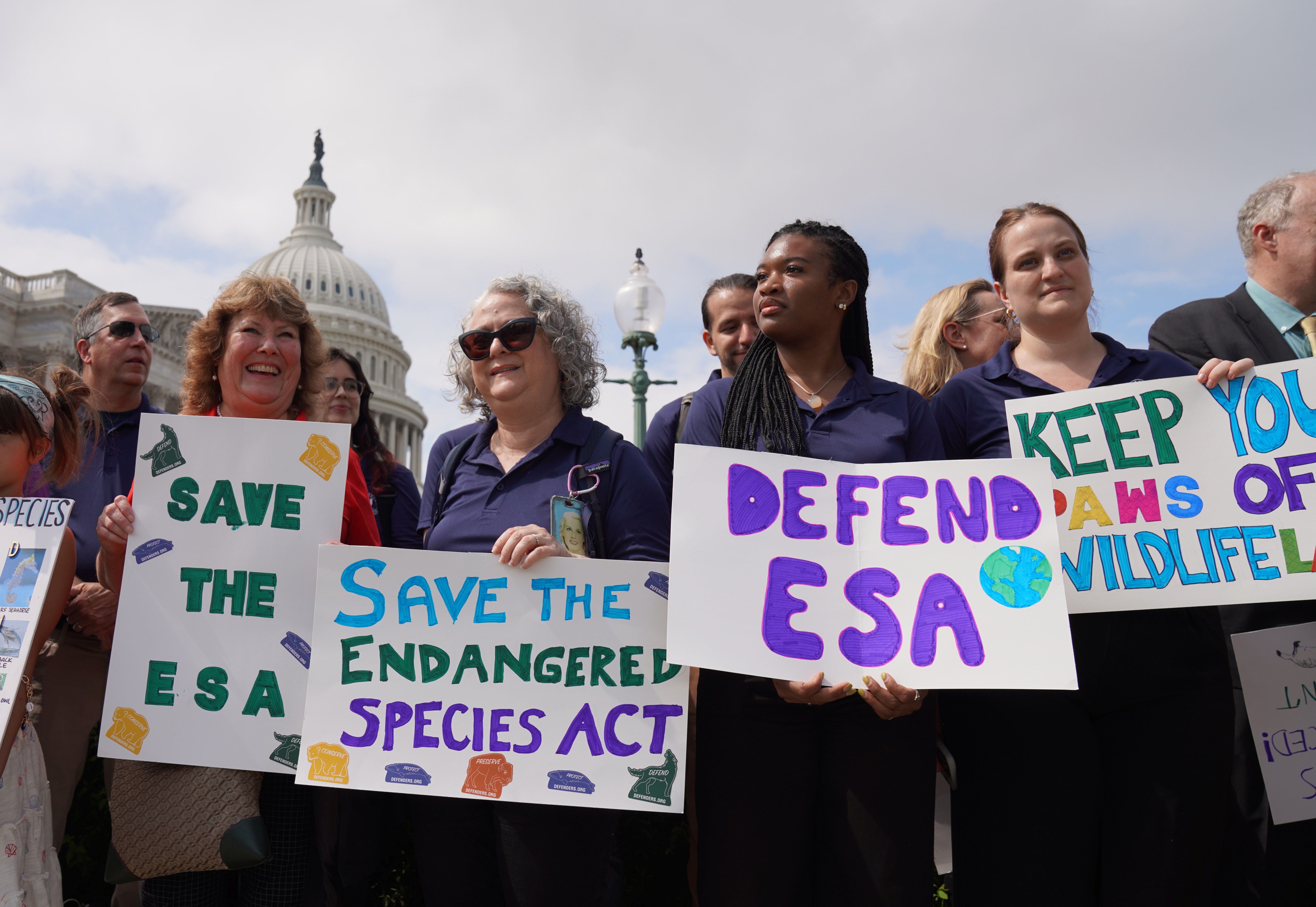 People holding Endangered Species Act signs